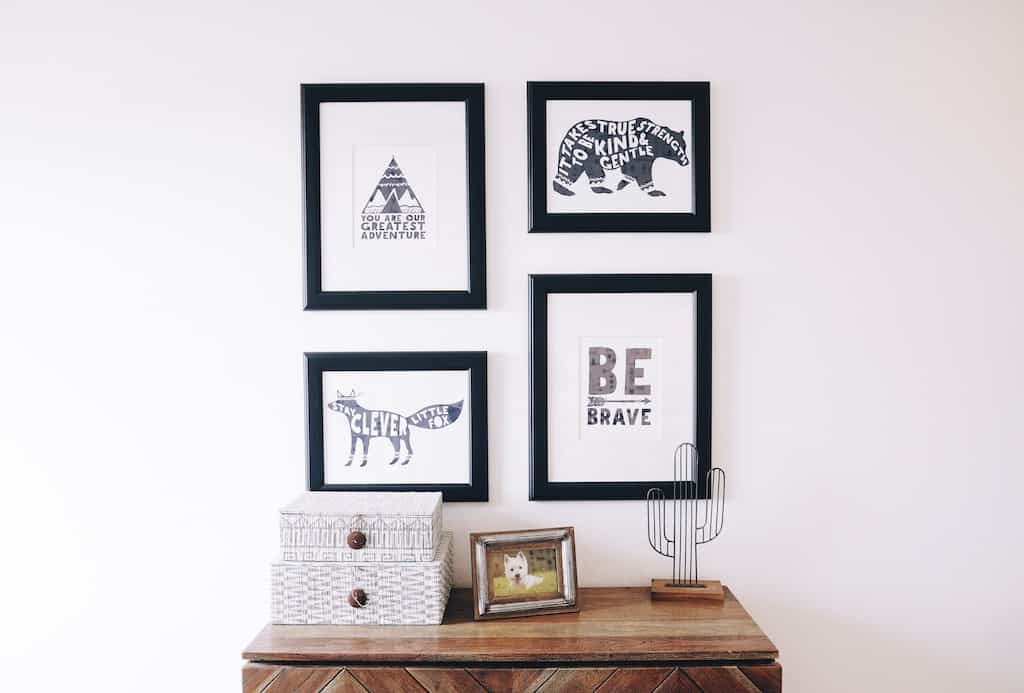 framed prints above a table
